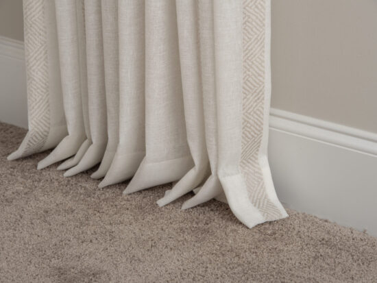 Unlined sheer linen drapery panels just breaking on the floor