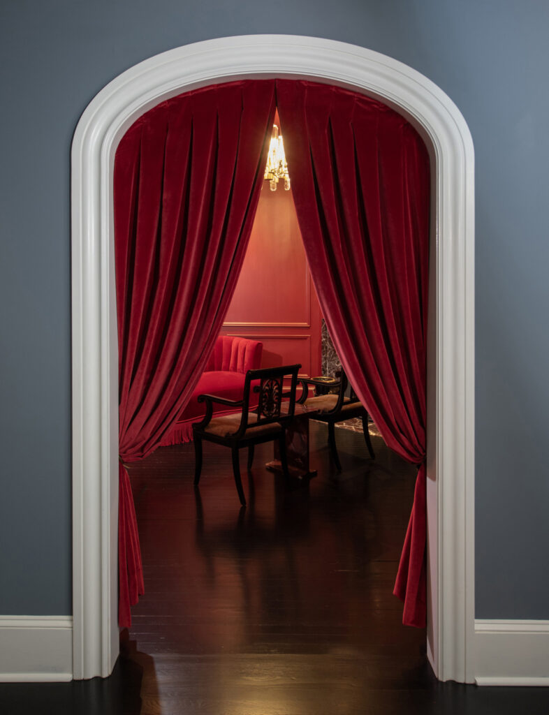 Double-sided velvet curtains installed with precision to create a seamless, speakeasy-style entry